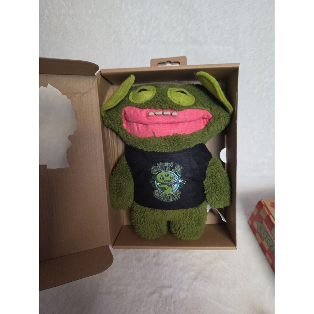 Fuggler FuggGlow "Grin Grin" stuffed animal. 
It is a 9.4-inch green plush